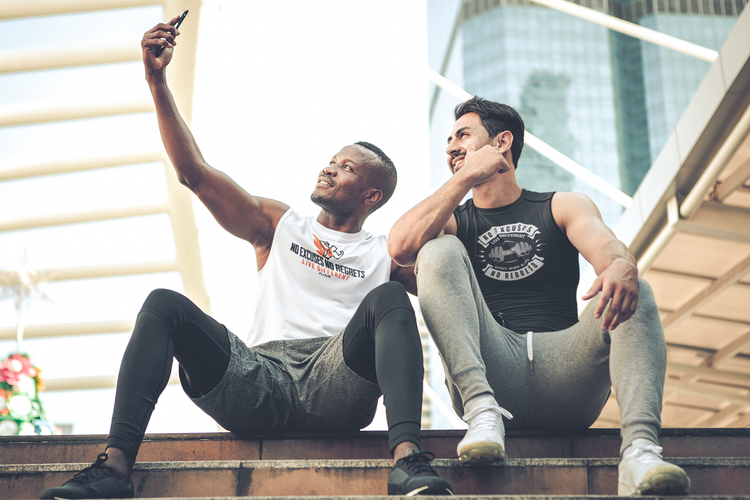 Two buddies hanging out wearing NENR FITNESS tanks